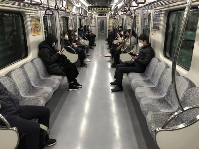 Passengers wear face masks on a subway train in Daegu, South Korea