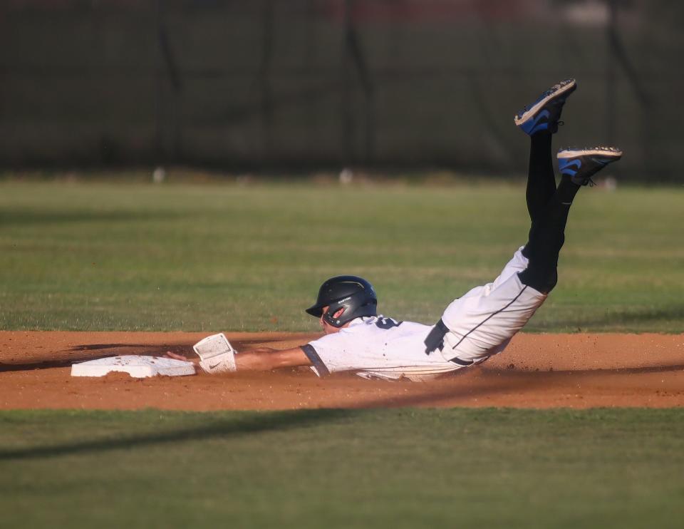 Designated runner Mario Guillen secures a steal with a belly-flop for Hendrickson.