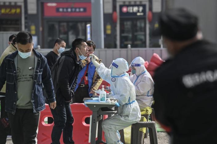 <div class="inline-image__caption"><p>A health worker takes a swab sample from a man to be tested for COVID-19 at a testing site along a street in Beijing on March 15, 2022.</p></div> <div class="inline-image__credit">Jade Gao/AFP via Getty</div>