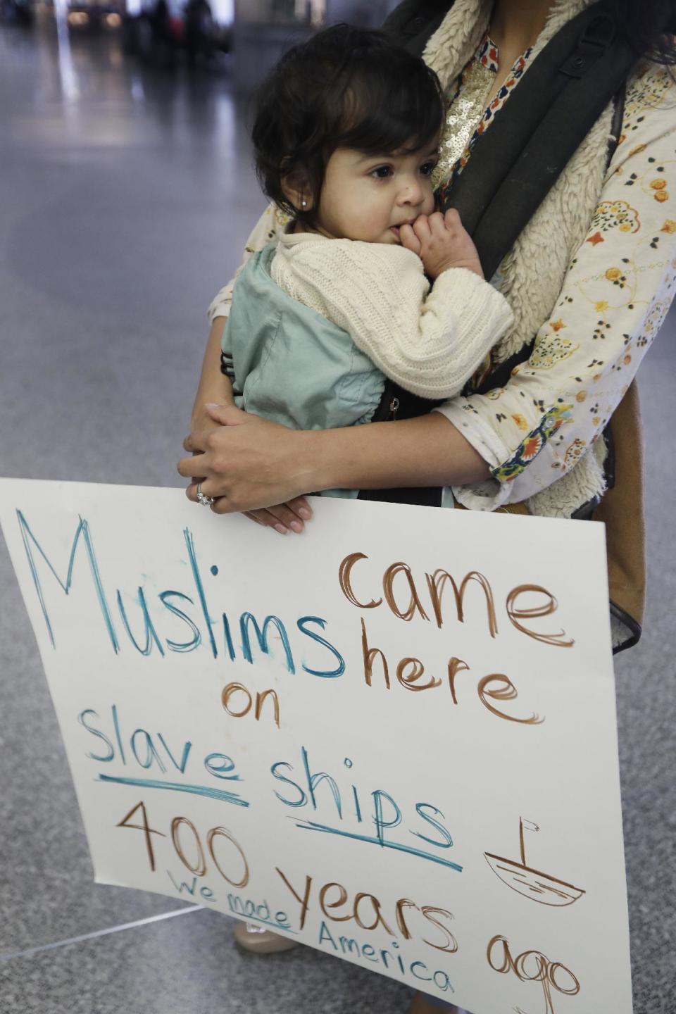 Amal Khan holds her one-year-old daughter Razan Sofia Bashir at San Francisco International Airport as she protests President Donald Trump's executive order that bars citizens of seven predominantly Muslim-majority countries from entering the U.S. Monday, Jan. 30, 2017, in San Francisco. (AP Photo/Marcio Jose Sanchez)