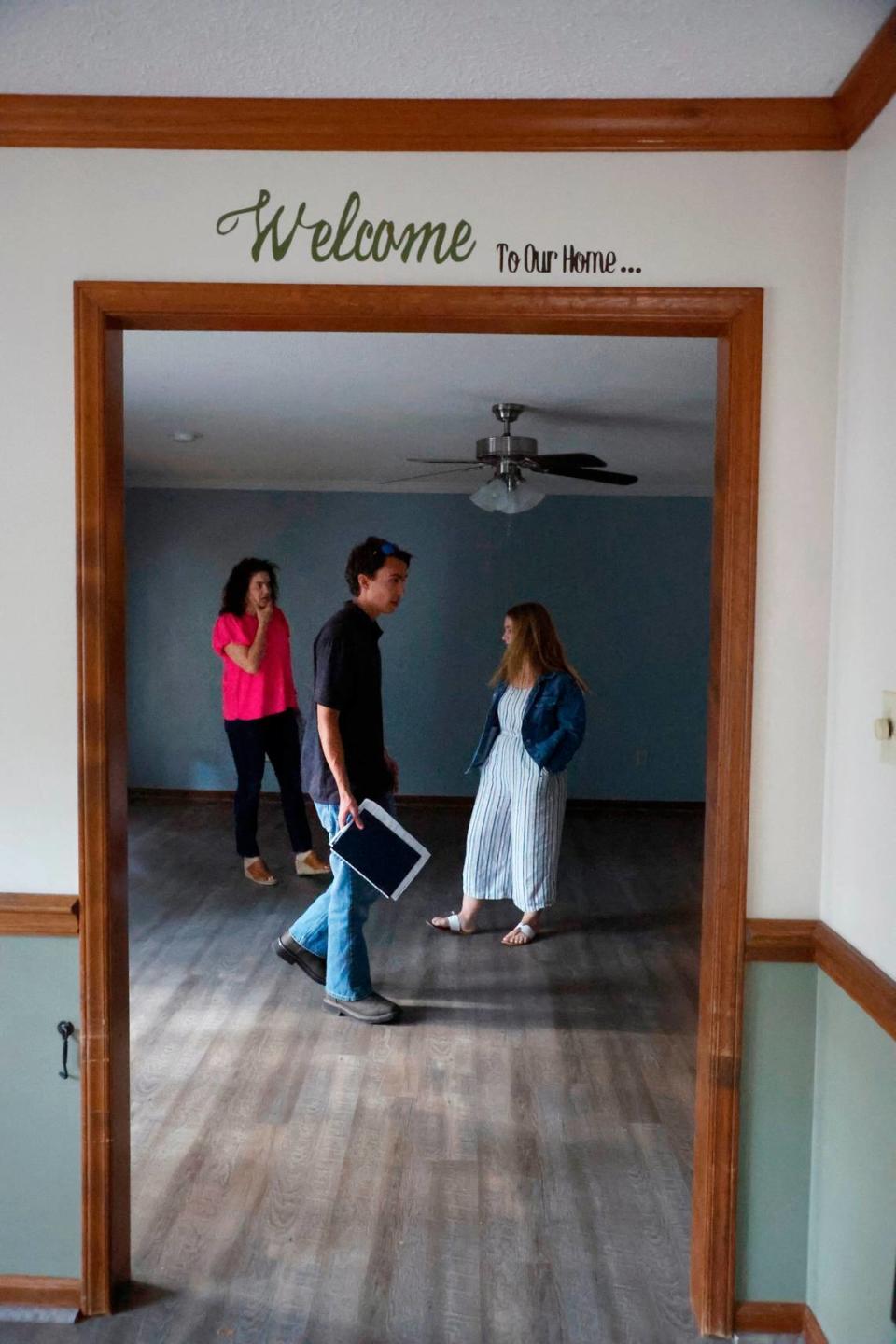 Brandon Thomas, his fiancee Corinne Enlow and Realtor AnnMarie Janni look over a home in Clayton while touring houses for sale in Garner and Clayton, N.C., on Tuesday, May 2, 2023. Ethan Hyman/ehyman@newsobserver.com