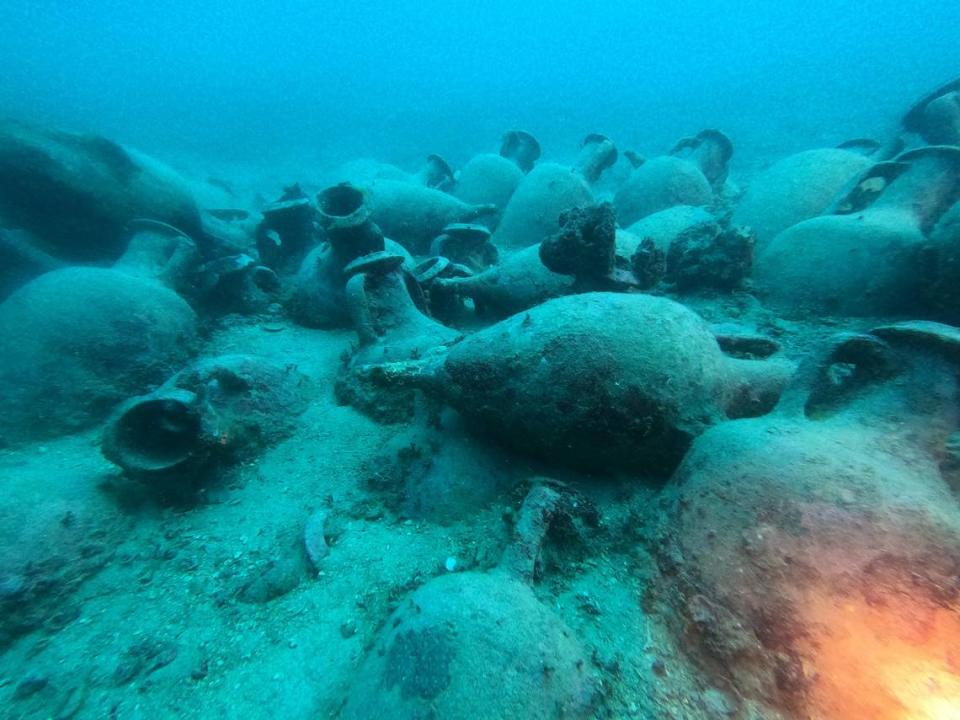 A close-up photo shows the ancient Roman pottery that sank with the ship.