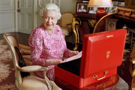 Britain's Queen Elizabeth sits in her private audience room in Buckingham Palace next to one of her official red boxes in which she receives documents and papers from government officials in the United Kingdom and the Commonwealth in this handout photograph taken by Mary McCartney and released September 8, 2015 in London, to mark the moment she becomes Britain's longest reigning monarch. REUTERS/Mary McCartney/Copyright: Her Majesty Queen Elizabeth II/Handout via Reuters