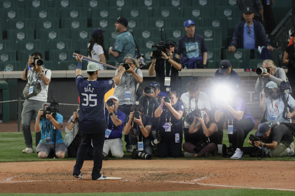 National League's Elias Díaz (35), of the Colorado Rockies, holds up his MVP award after the MLB All-Star baseball game in Seattle, Tuesday, July 11, 2023. (AP Photo/John Froschauer)