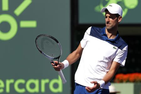 Mar 23, 2018; Key Biscayne, FL, USA; Novak Djokovic of Serbia gestures after missing a shot against Benoit Paire of France (not pictured) on day four of the Miami Open at Tennis Center at Crandon Park. Paire won 6-3, 6-4. Mandatory Credit: Geoff Burke-USA TODAY Sports