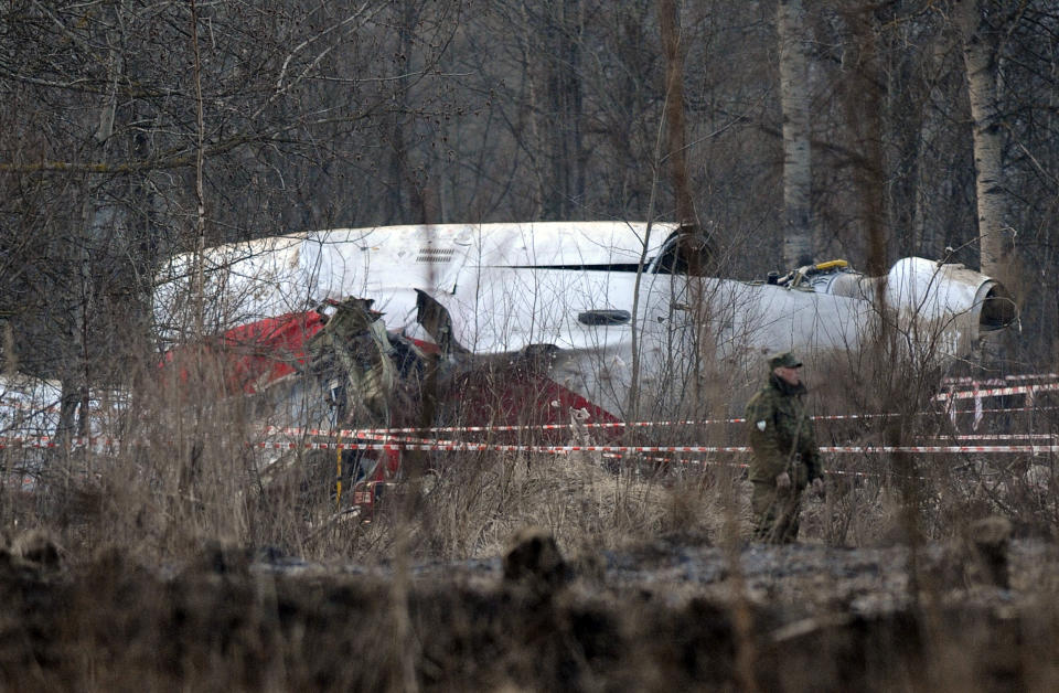 A Russian soldier stands guard near the wreckage of a Polish government aircraft that crashed the previous day.