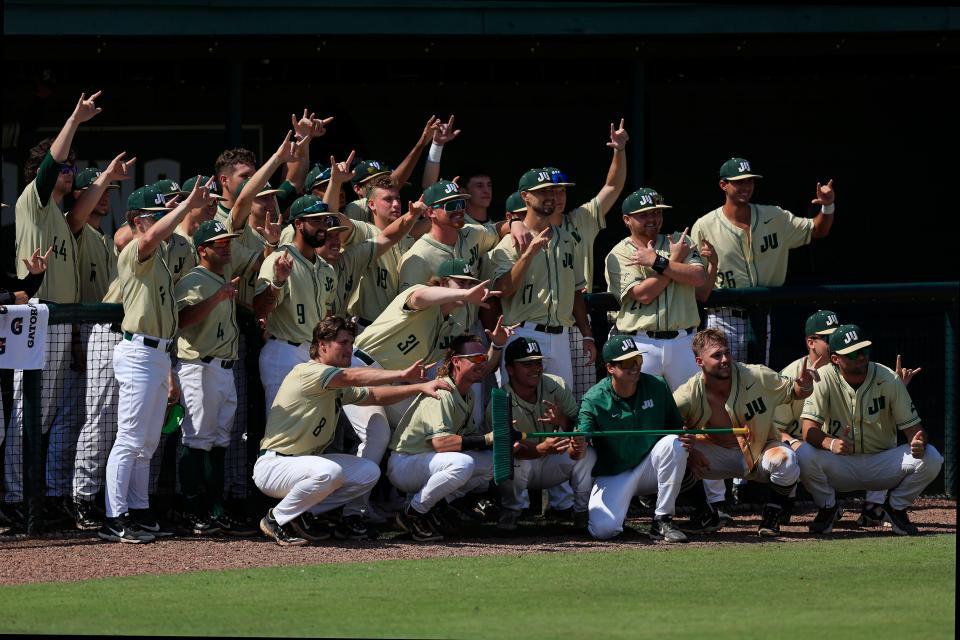JU players celebrate their 3-2 victory over the University of North Florida on Saturday with a broom, signifying their first season sweep since 2006 in the River City Rumble.