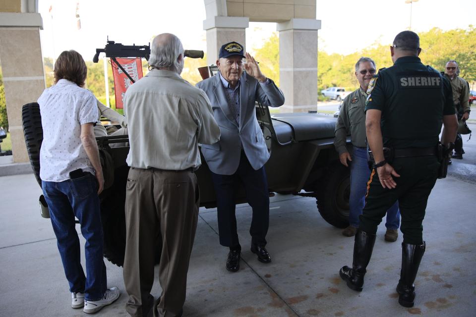 John L. Patton, 100, acknowledges the crowd of well-wishers who greeted him at a ceremony honoring his World War II service.