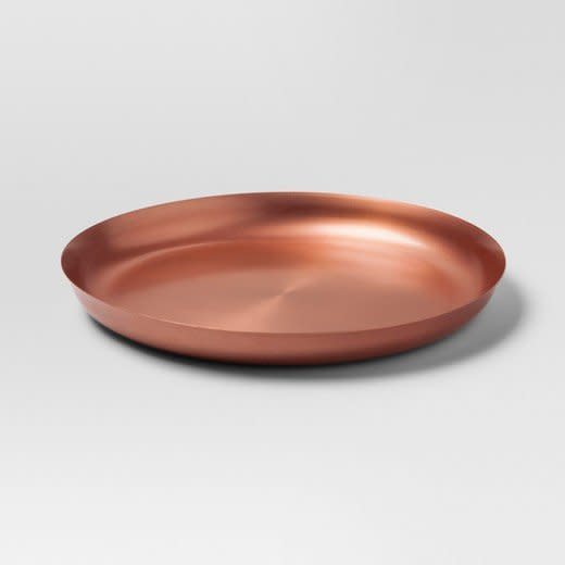 <a href="https://www.target.com/p/round-serving-platter-copper-project-62-153/-/A-52311259#lnk=newtab" target="_blank">Shop it here</a>.&nbsp;