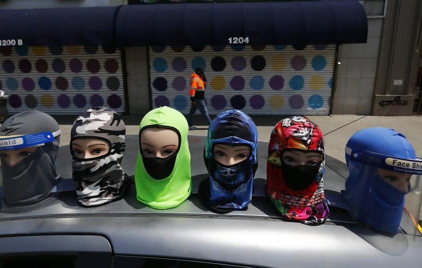 LOS ANGELES, CALIF. - APR. 29, 2020. Shuttered storefronts and protective masks for sale in the garment district of Los Angeles on Wednesday, April 29, 2020. California's unemployment rate has skyrocketed since the statewide coronavirus shutdown took effect. Nationwide it's the highest since the Great Depression. (Luis Sinco/Los Angeles Times)