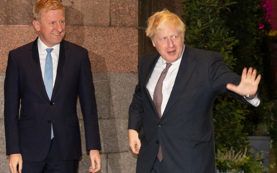 Oliver Dowden and Boris Johnson pictured during happier times at last year's Tory party conference - Jon Super/AP Photo / File