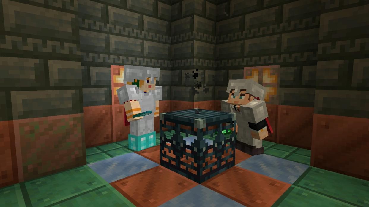  Minecraft 1.21 - Two players stand together in a copper Trial Chamber looking at a Trial Spawner block. 