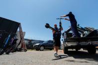 John Heinkel and Dan Borelli unload a truckload of impounded scooters at their facility in San Diego , California