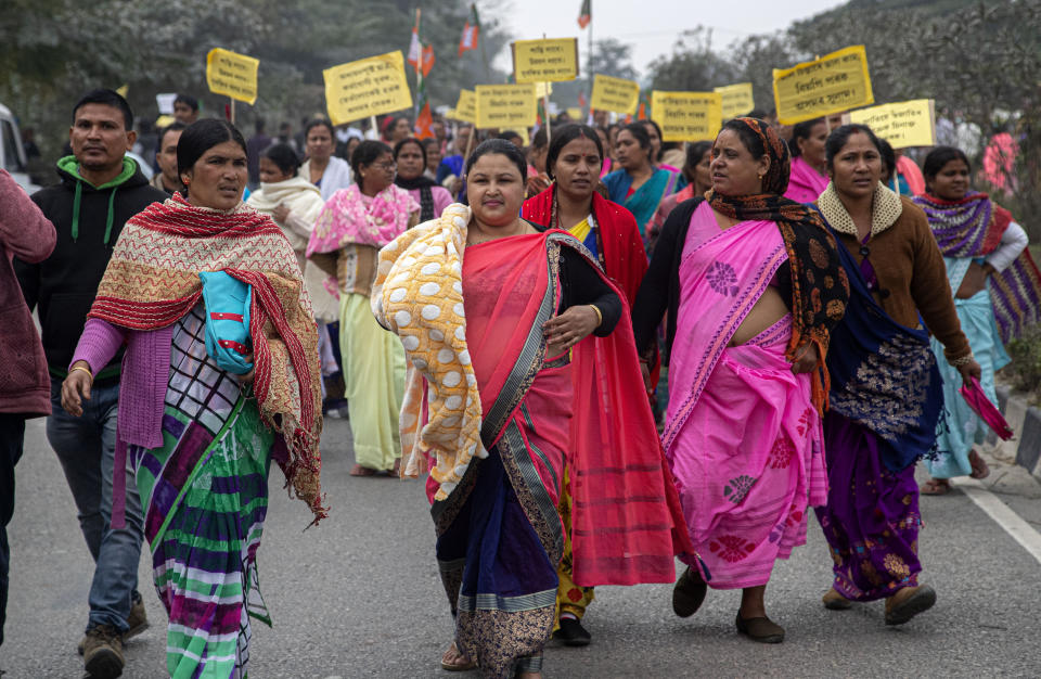 Activists of India's ruling Bharatiya Janata Party (BJP) participate in a procession urging for peace after violence broke out in several parts of the country during protests against the Citizenship Amendment Act, in Nalbari, India, Friday, Dec. 20, 2019. Police banned public gatherings in parts of the Indian capital and other cities for a third day Friday and cut internet services to try to stop growing protests against a new citizenship law that have left 11 people dead and more than 4,000 others detained. (AP Photo/Anupam Nath)