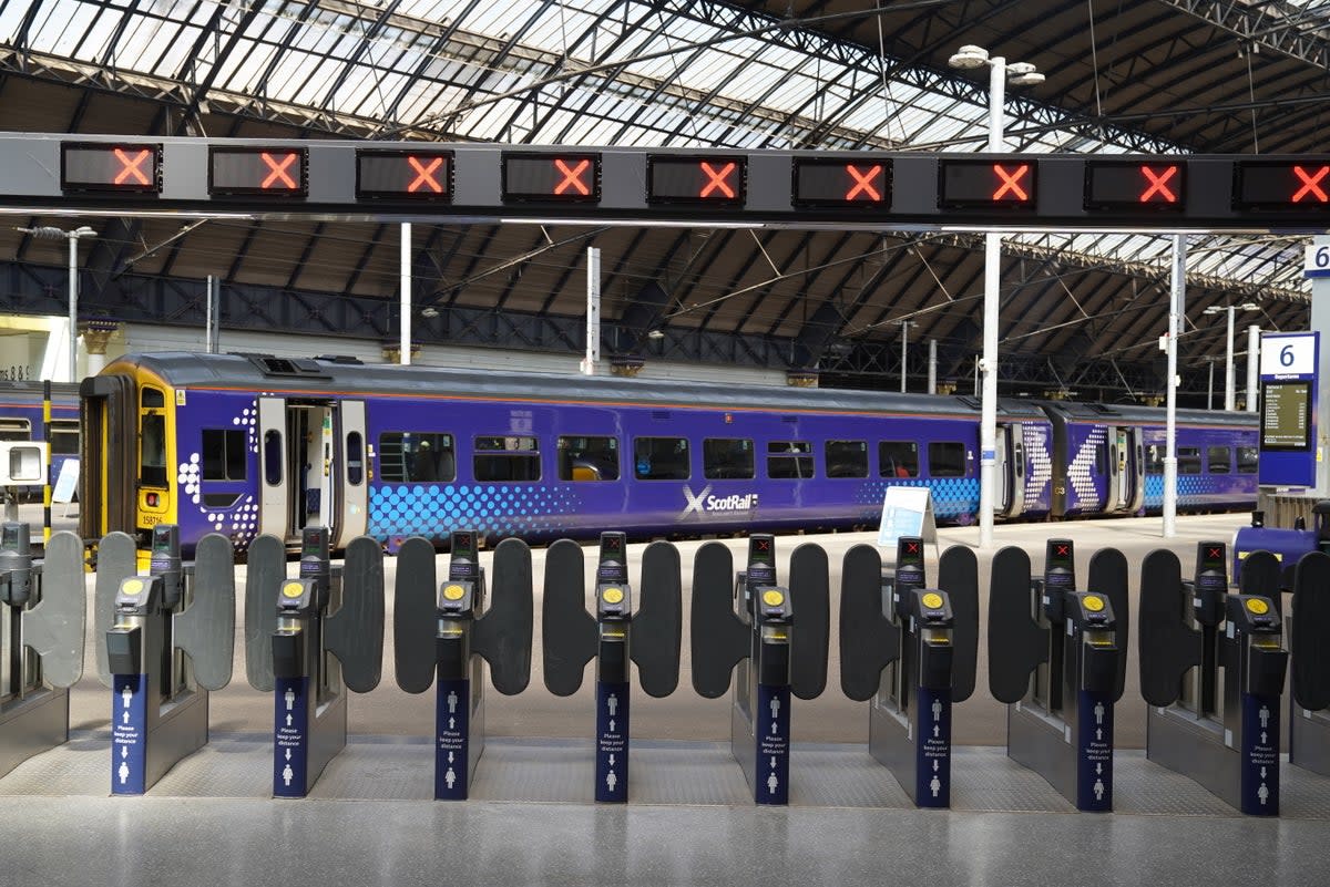 Signs at Glasgow Queen Street station alert travellers to the strike action (PA) (PA Wire)