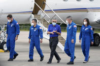 Kennedy Space Center director Bob Cabana, center, welcomes SpaceX Crew 2 astronauts, from left, European Space Agency astronaut Thomas Pesquet, Japan Aerospace Exploration Agency astronaut Akihiko Hoshide, and NASA astronauts Shane Kimbrough and Megan McArthur as they arrive at the Kennedy Space Center in Cape Canaveral, Fla., Friday, April 16, 2021. The launch to the International Space Station is targeted for April 22. (AP Photo/John Raoux)