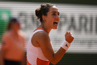 Italy's Martina Trevisan clenches her fist after scoring a point against Coco Gauff of the U.S. during their semifinal match at the French Open tennis tournament in Roland Garros stadium in Paris, France, Thursday, June 2, 2022. (AP Photo/Michel Euler)