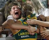 <p>Brazil’s Larissa Franca, center, is hugged by loved ones after beating Switzerland during a women’s beach volleyball quarterfinal match at the 2016 Summer Olympics in Rio de Janeiro, Brazil, Sunday, Aug. 14, 2016. (AP Photo/Marcio Jose Sanchez) </p>