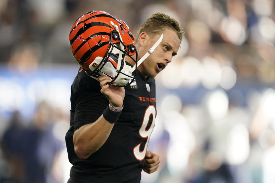 Cincinnati Bengals quarterback Joe Burrow (9) celebrates a two point conversion during the second half of an NFL football game against he Dallas Cowboys Sunday, Sept. 18, 2022, in Arlington, Tx. (AP Photo/Tony Gutierrez)