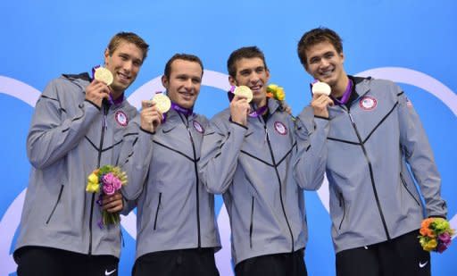 L-R: US swimmers Matthews Grevers, Brendan Hansen, Michael Phelps and Nathan Adrian pose on the podium with the gold medal after winning the men's 4x100 medley relay final during the swimming events at the London 2012 Olympic Games