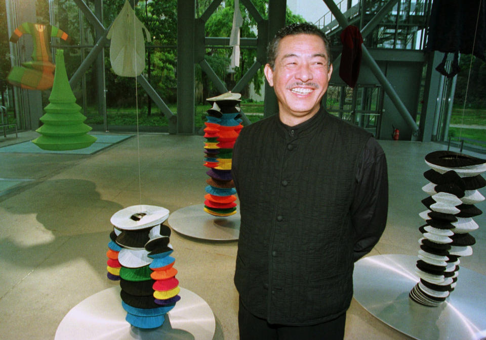 FILE - Japanese fashion designer Issey Miyake smiles while inaugurating the exhibition "Making Things" in Paris on Oct. 11, 1998. Miyake, who built one of Japan’s biggest fashion brands and was known for his boldly sculpted pleated pieces as well as former Apple CEO Steve Jobs’ black turtlenecks, has died. He was 84. He died Aug. 5, 2022, of liver cancer, Miyake Design Office said Tuesday, Aug. 9. (AP Photo/Michel Euler, File)