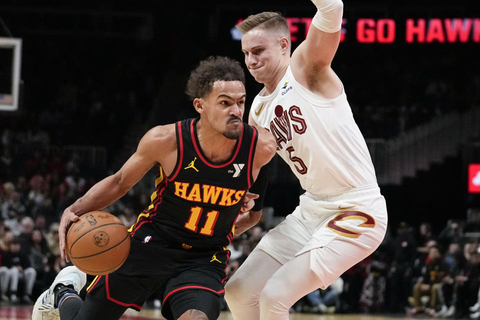 Atlanta Hawks guard Trae Young (11) drives the ball to the basket against Cleveland Cavaliers guard Sam Merrill (5) in the first half of an NBA basketball game, Saturday, Jan. 20, 2024, in Atlanta. (AP Photo/Brynn Anderson)