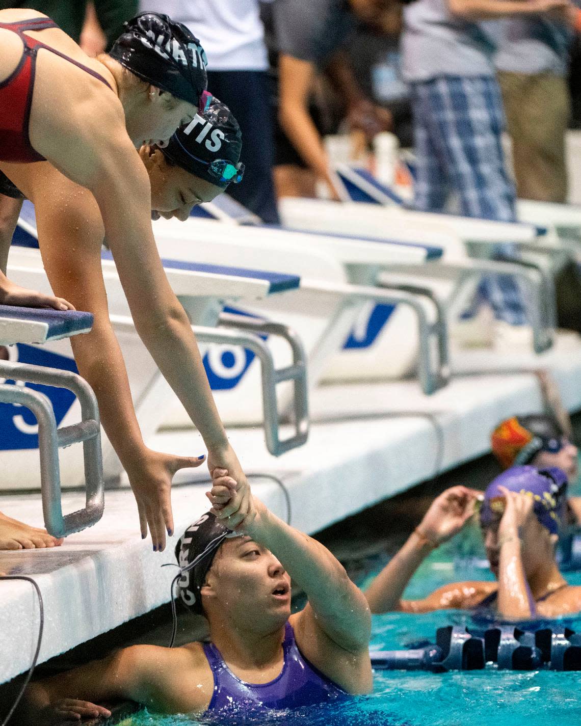 Curtis’ Alexa Proctor is congratulated by her relay teammates after the team won the 200-yard Medley Relay at the State 4A Swimming and Diving finals on Saturday, Nov. 12, 2022, at the King County Aquatic Center in Federal Way, Wash. Proctor swam the freestyle, while teammates Athea Caritativo (backstroke), May Guidoux (breast stroke) and Trinity Link (butterfly) also helped propel the Vikings to the win.