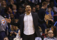 Oklahoma City Thunder guard Russell Westbrook shouts to his teammates from the bench area in the second quarter of an NBA basketball game against the Sacramento Kings in Oklahoma City, Sunday, Jan. 19, 2014. Westbrook is out with an injured knee. (AP Photo/Sue Ogrocki)