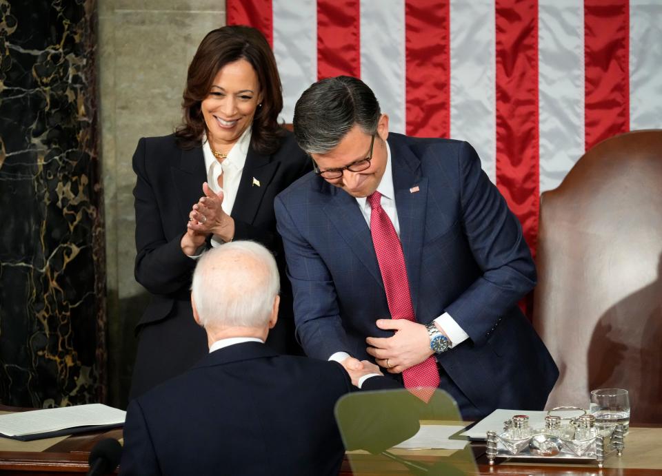 President Joe Biden shakes hands with Speaker of the House Mike Johnson after delivering the State of the Union address to Congress at the U.S. Capitol in Washington March 7, 2024. At left is Vice President Kamala Harris.