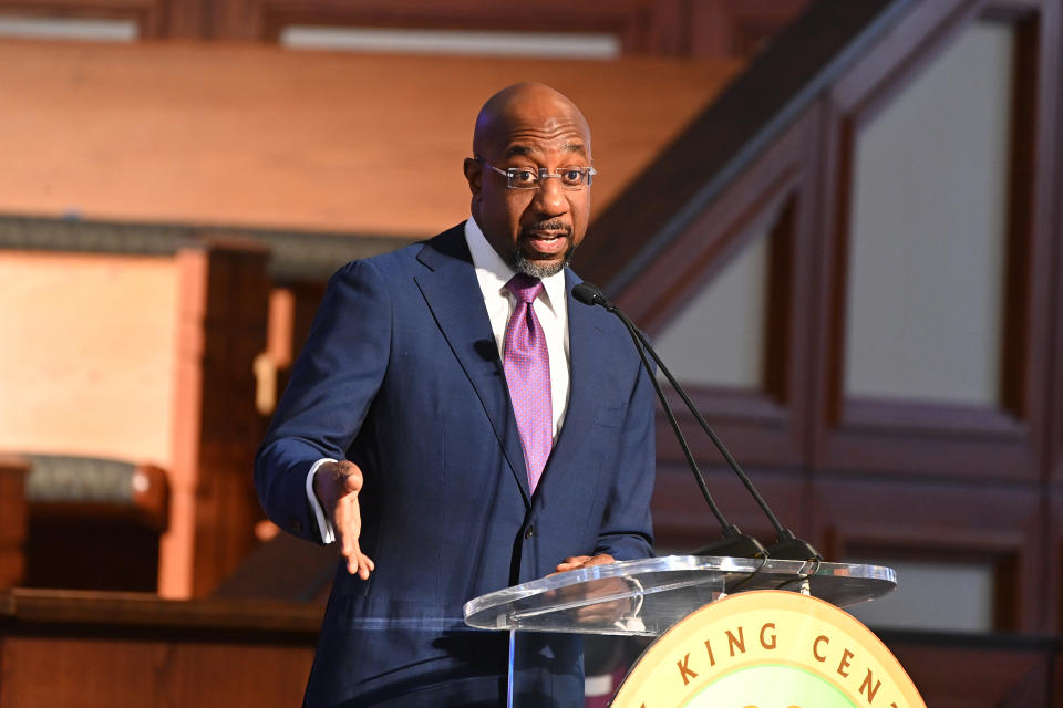 Sen. Raphael Warnock makes a point at the podium.