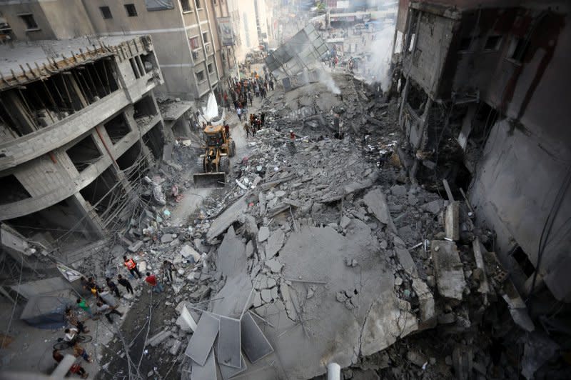 Palestinians inspect the destruction following Israeli airstrikes on a market in residential neighborhood in Khan Younis, southern Gaza Strip on Tuesday. Photo by Ismael Mohamad/UPI