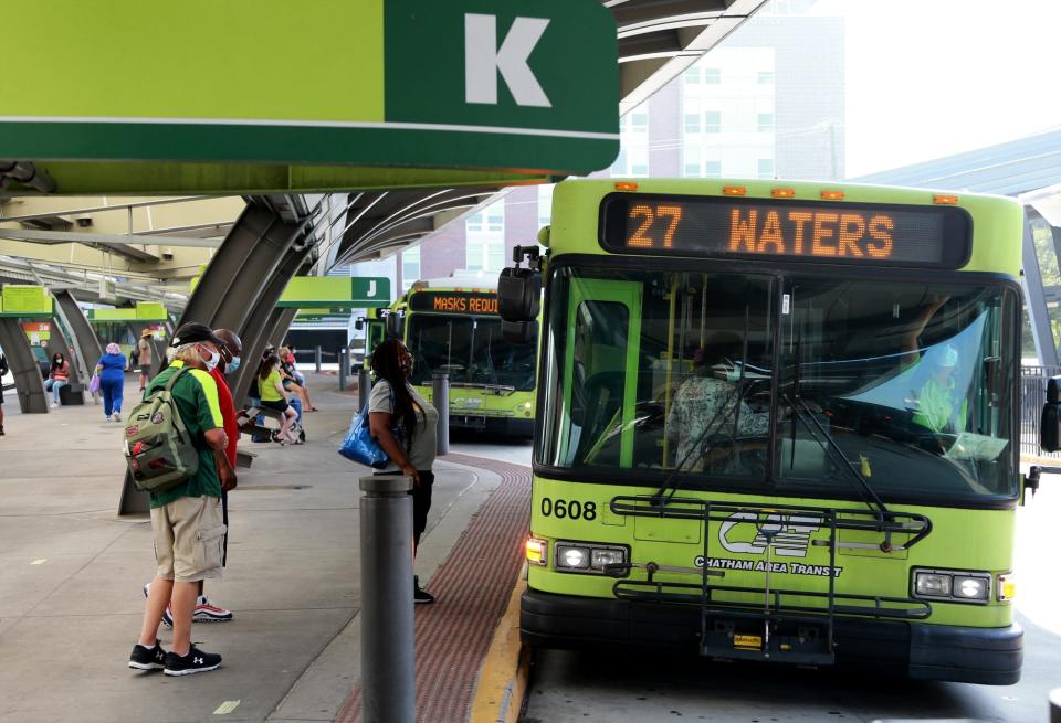 Passengers board a bus at the Chatham Area Transit Intermodal Transit Center.