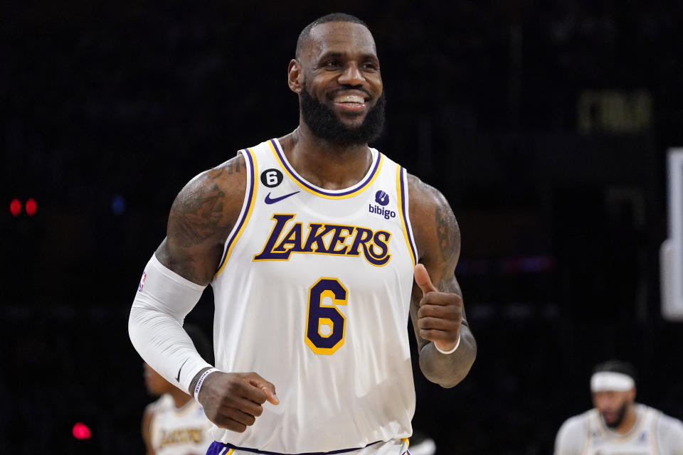 Los Angeles Lakers forward LeBron James smiles after scoring during the second half of an NBA basketball game against the Utah Jazz Sunday, April 9, 2023, in Los Angeles. (AP Photo/Mark J. Terrill)