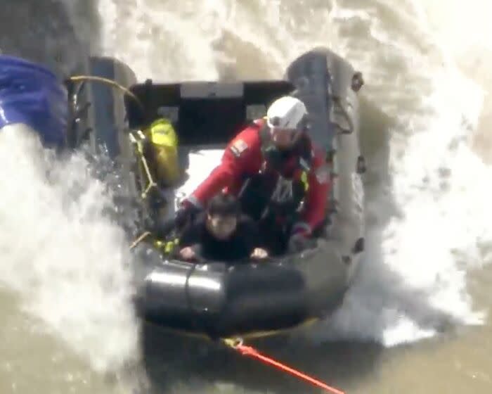 A 23-year-old homeless man trapped in fast-moving storm runoff in the concrete-lined Pacoima Wash was rescued from the flood control channel Tuesday morning, according to the Los Angeles Fire Department.