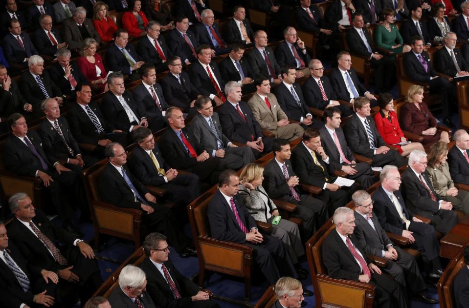 Republican members of congress listen as U.S. President Barack Obama delivers his State of the Union address to a joint session of the U.S. Congress on Capitol Hill in Washington