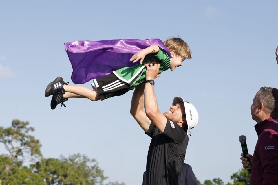 Peter Malnati tosses his son Hatcher, top, into the air after winning the Valspar Championship golf tournament. Mandatory Credit: Reinhold Matay-USA TODAY Sports