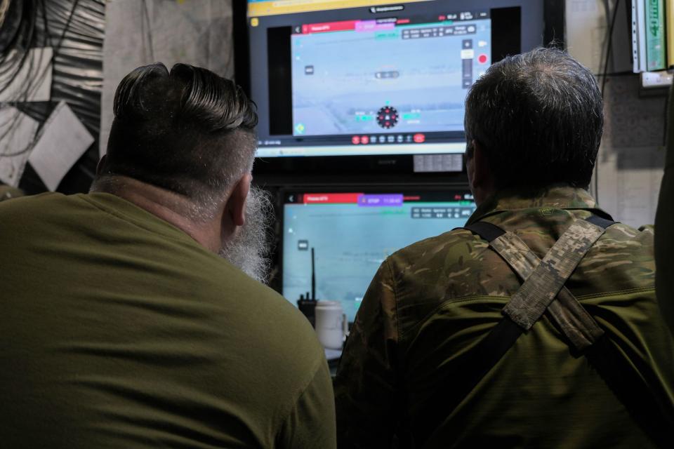 Ukrainian soldiers of the 110th Territorial Defense Brigade examine drone footage of Russian defensive lines on May 25, 2023. (Photo: Francis Farrell/The Kyiv Independent)