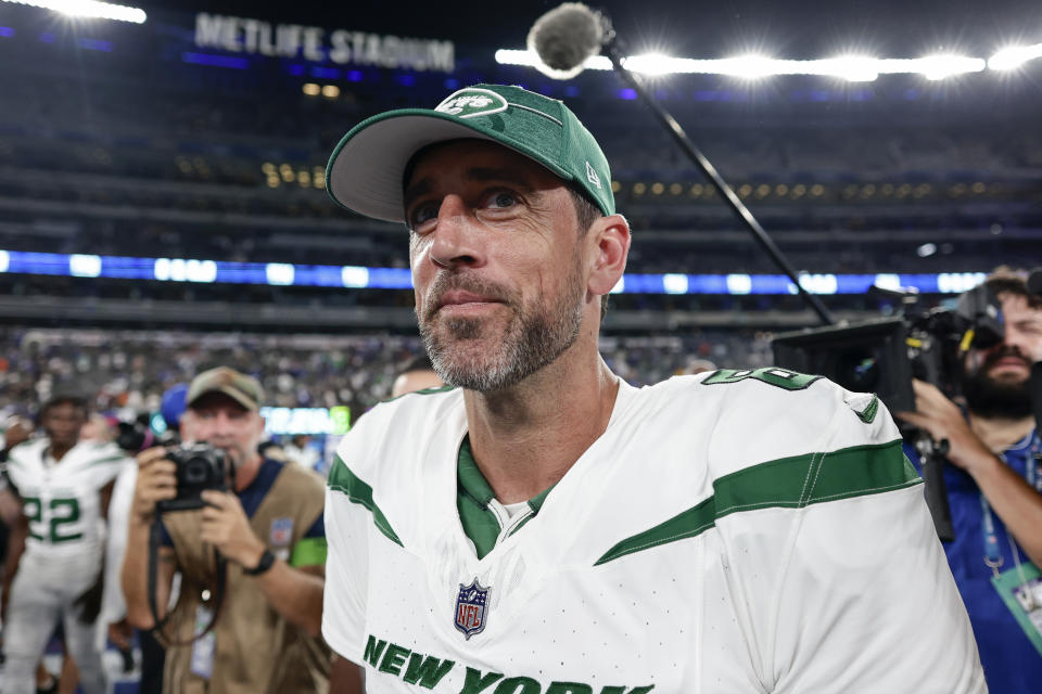 New York Jets quarterback Aaron Rodgers (8) walks to the lorckerrooms after winning an NFL preseason football game against the New York Giants, Saturday, Aug. 26, 2023, in East Rutherford, N.J. (AP Photo/Adam Hunger)