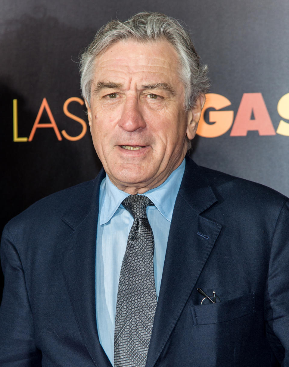 Robert De Niro wearing a dark suit and tie at a film premiere