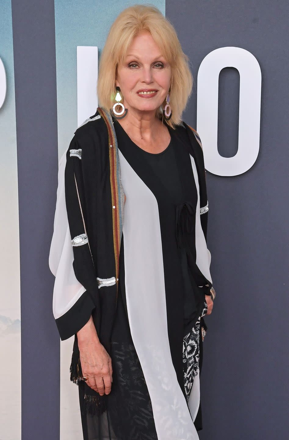 joanna lumley poses for pictures on red carpet