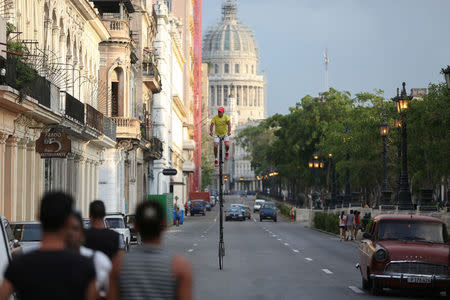 Felix Guirola, 52, rides a homemade bike with an advertising banner in Havana, Cuba. Cubans are adept at inventing ways to earn cash but Felix Guirola stands - or rather, cycles - head and shoulders above them. REUTERS/Alexandre Meneghini