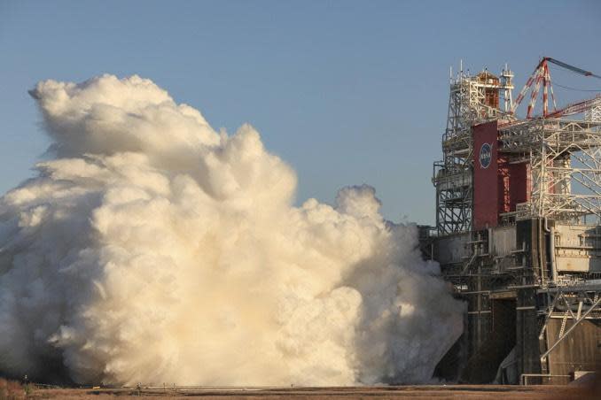 Clouds of steam erupt from the base of the B-2 test stand at NASA's Stennis Space Center in Mississippi as the four RS-25 engines throttle up to full power, their exhaust vaporizing torrents of cooling water. / Credit: NASA