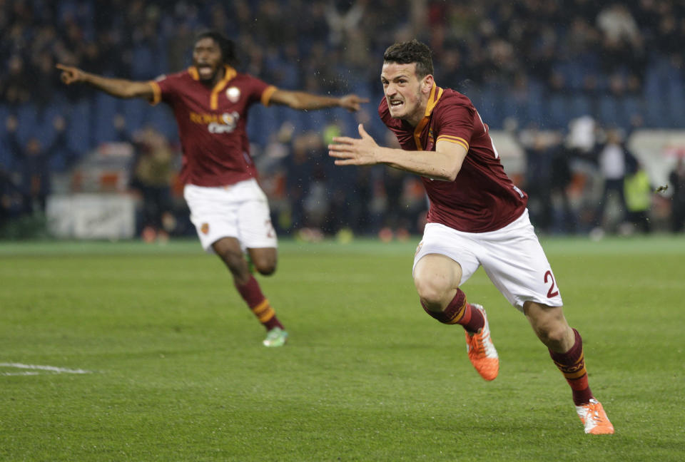 AS Roma midfielder Alessandro Florenzi, right, celebrates after he scored during a Serie A soccer match between AS Roma and Torino, at Rome's Olympic Stadium, Tuesday, March 25, 2014. (AP Photo/Andrew Medichini)