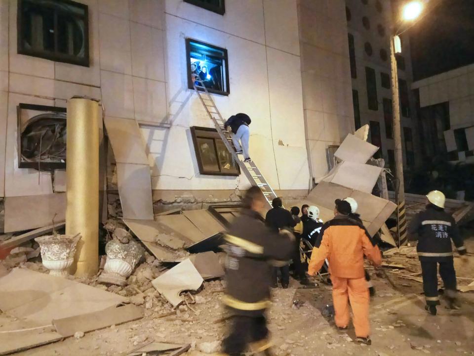 <p>Rescue workers search through rubble outside the Marshal Hotel in Hualien, eastern Taiwan early Feb. 7, 2018, after a strong earthquake struck the island.<br> (Photo: AFP/Getty Images) </p>