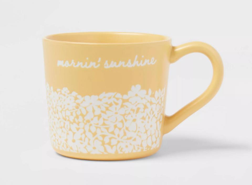 Yellow ceramic mug with floral pattern and "morning’s sunshine" text