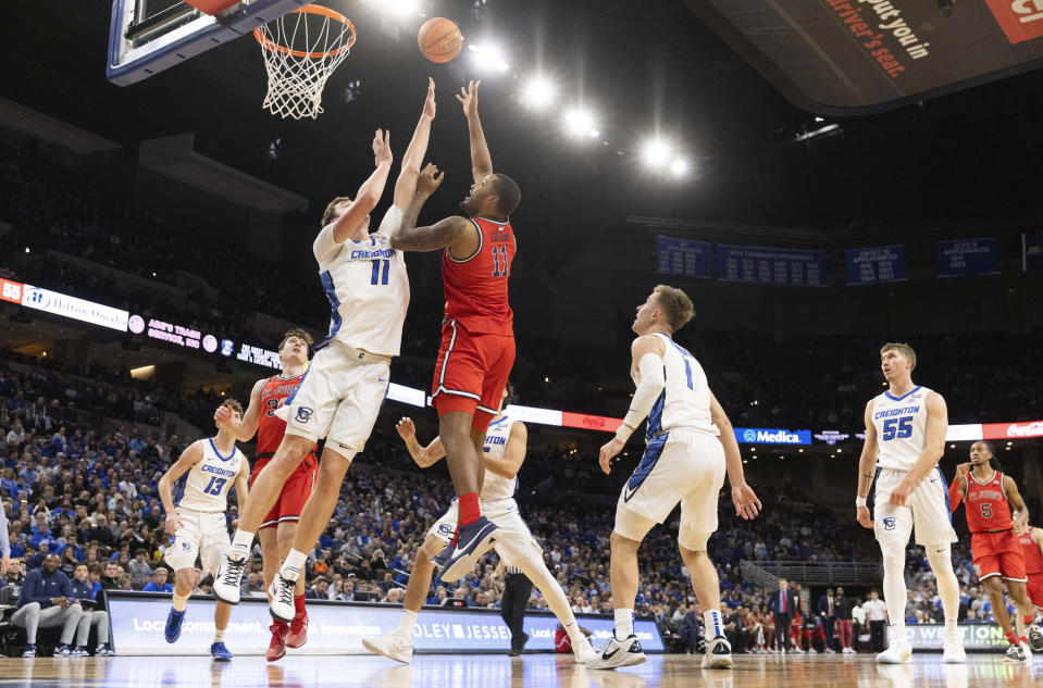 St. John's Joel Soriano, center right, shoots over Creighton's Ryan Kalkbrenner, center left, during the first half of an NCAA college basketball game Saturday, Jan. 13, 2024, in Omaha, Neb. (AP Photo/Rebecca S. Gratz)