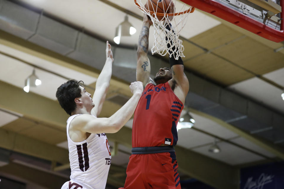 Dayton forward Obi Toppin (1) slam dunks over Virginia Tech guard Hunter Cattoor (0) during the first half of an NCAA college basketball game Tuesday, Nov. 26, 2019, in Lahaina, Hawaii. (AP Photo/Marco Garcia)