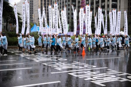 People march holding banners denouncing Japanese Prime Minister Shinzo Abe and his economic sanctions during an anti-Japan protest on Liberation Day in Seoul