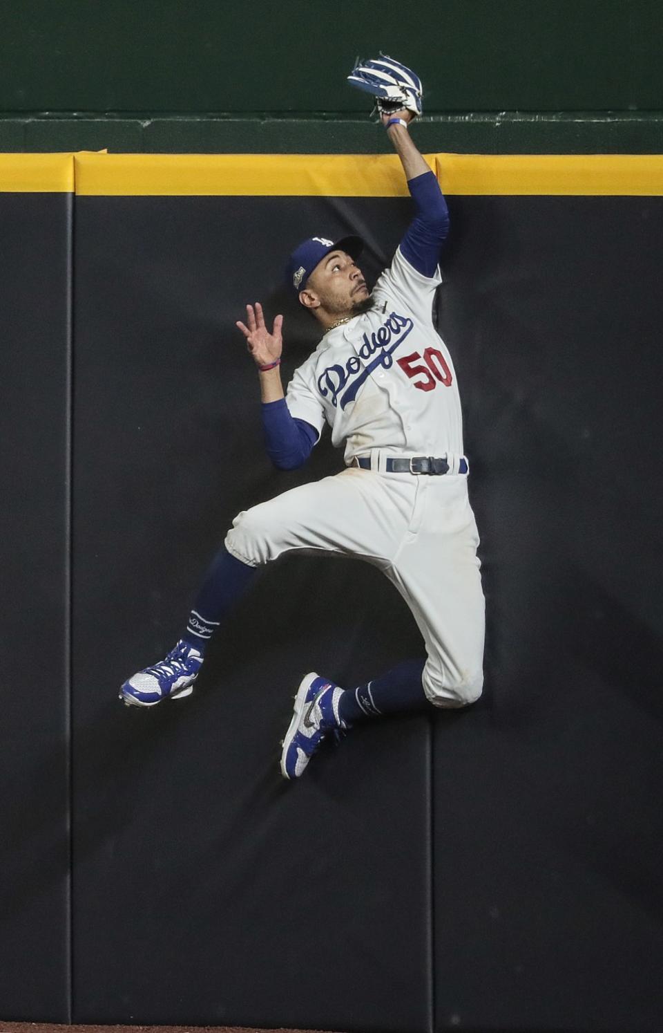 Dodgers right fielder Mookie Betts robs Atlanta Braves first baseman Freddie Freeman of a fifth inning homer.