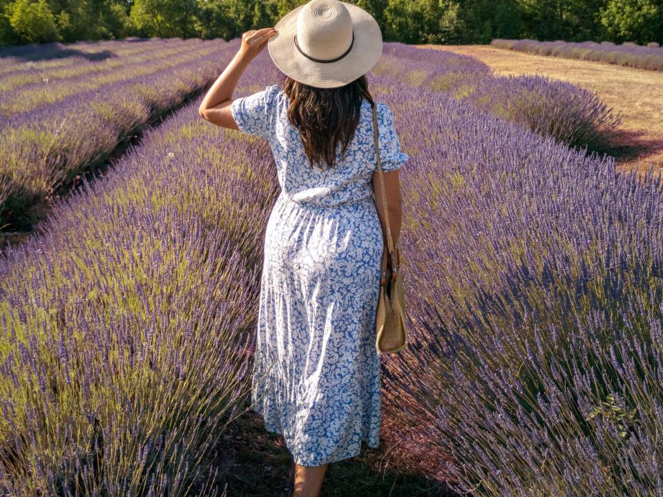 Woman wearing white sundress in a field